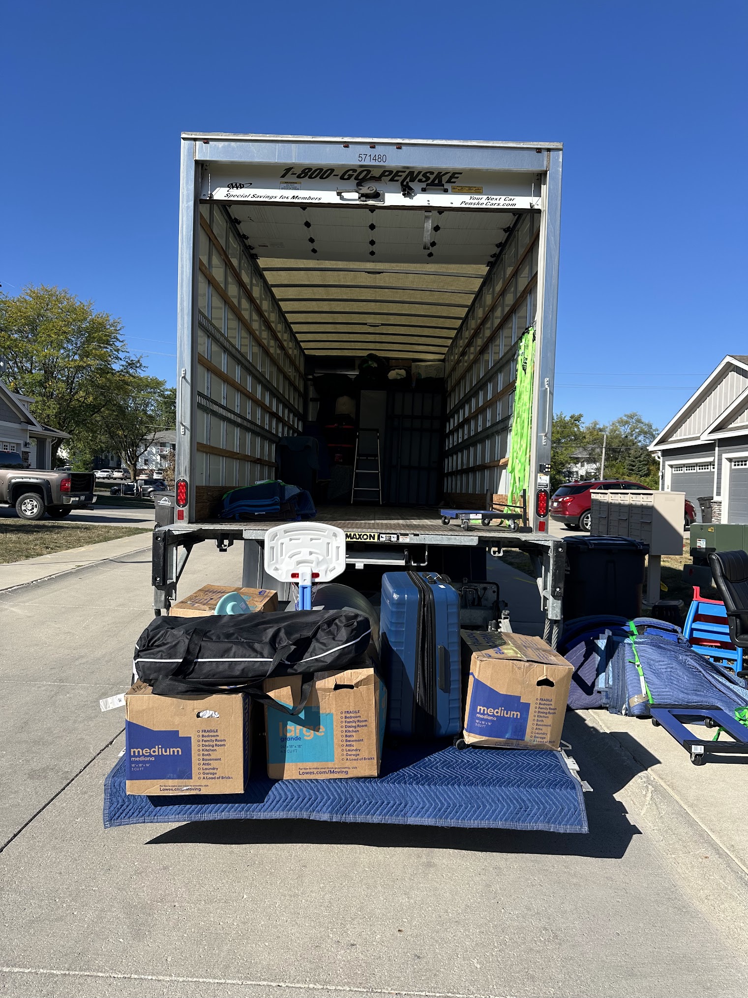 Residential moving crew carrying furniture from a Des Moines home